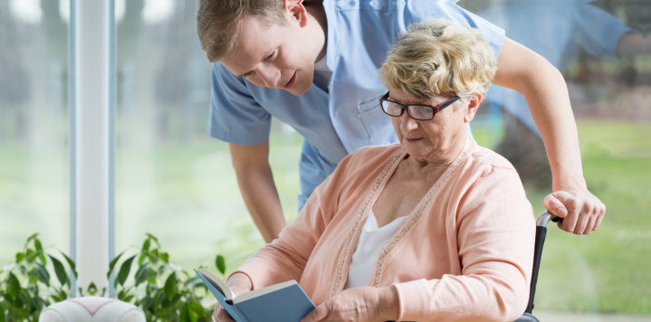 elderly woman reading a book